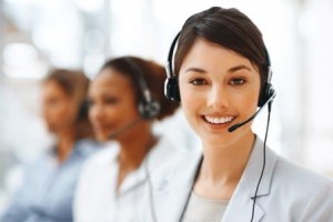 Closeup of a cute business woman with headset at workplace