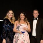 Rebecca Rees from HSBC UK (IBC) picks up the Team Leader of the Year award from comedian Katherine Ryan (left) and sponsor CGI