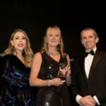 Nicola Hanigan from Lloyds Banking Group collects Senior Manager of the Year award from comedian Katherine Ryan (left) and sponsor Firstsource