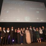 EE collect large contact centre of the year award from comedian Katherine Ryan(left)